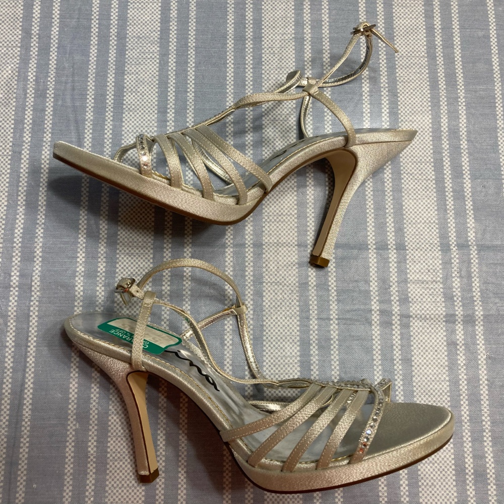 Nina silver dress heels with rhinestone front detail.